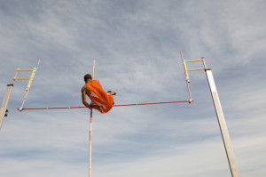 Pole vaulted in mid-air, low angle view